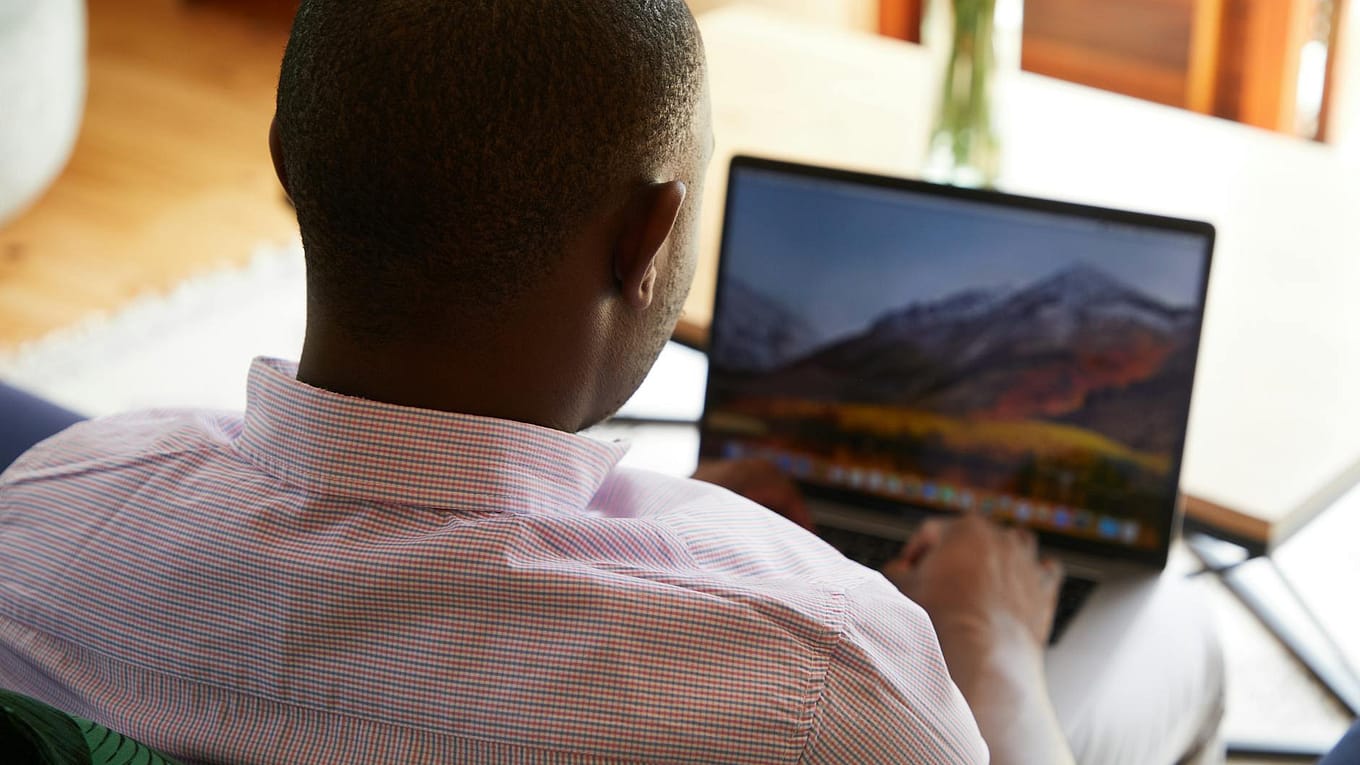 black man doing research with laptop